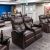 The theater room at our 55 and older community in Lakewood, CO, featuring cushioned chairs and carpeted flooring.